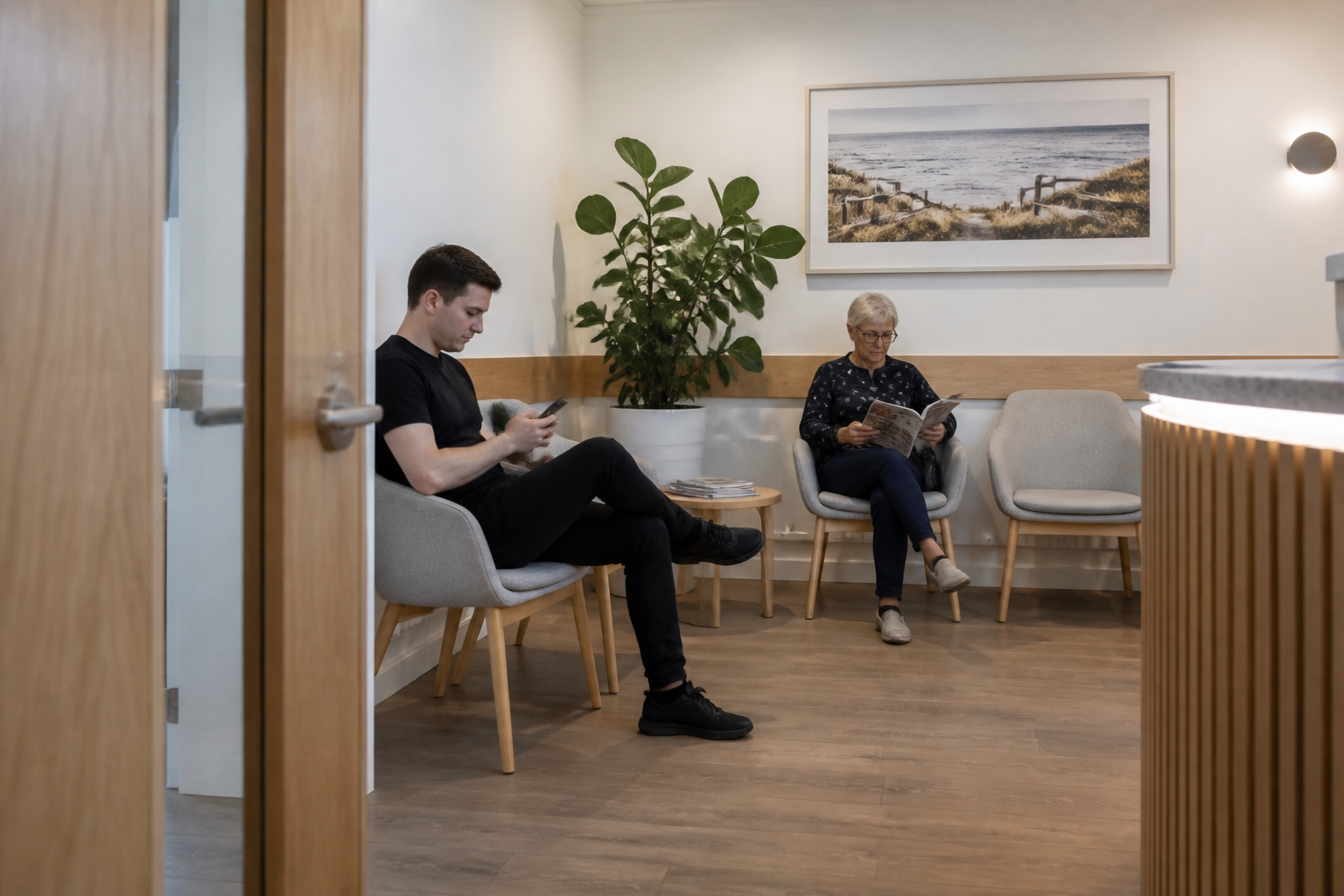 A dental waiting room with chairs, plants and natural light
